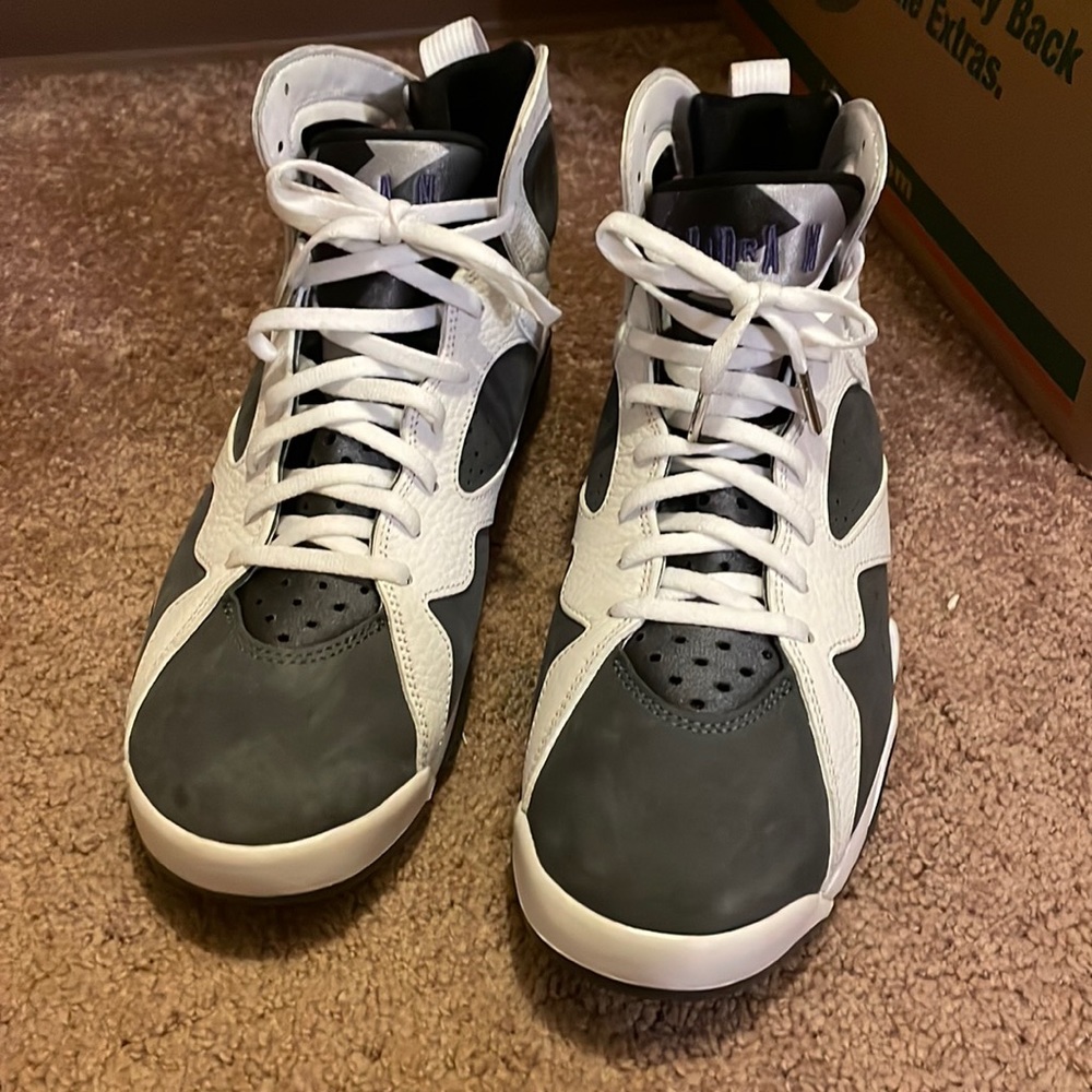 White and grey Jordan’s size 11. Purple and black on the symbol